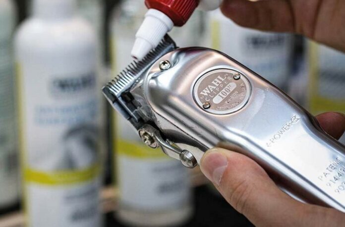 applying clipper oil on the blade of a wahl hair clipper